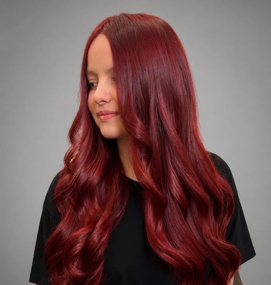 Long, rich red hair in soft, loose curls